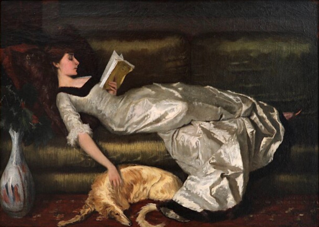 Oil painting of a woman in a silver gown reclining on a sofa, reading, with a dog at her side.